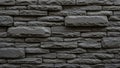 Stacked Dark Grey Stone Bricks with Rough Textured Surfaces Forming a Wall Pattern Royalty Free Stock Photo
