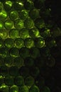 Close-up of a wall made out of green glass bottles. Green wine bottles or beer bottles stacked to make a wall. Travelling in Royalty Free Stock Photo