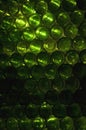 Close-up of a wall made out of green glass bottles. Green wine bottles or beer bottles stacked to make a wall. Travelling in Royalty Free Stock Photo