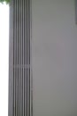 Close up of wall with vertical metal ventilation slats Royalty Free Stock Photo