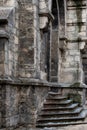 Close-up on the walls of a medieval temple. View of the ancient stone wall covered with thin layer of moss. Royalty Free Stock Photo