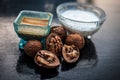 Close up of walnut face pack to prevent hair damage on wooden surface i.e. walnut powder well mixed with curd in a glass bowl with Royalty Free Stock Photo