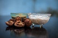 Close up of walnut face pack to prevent hair damage on wooden surface i.e. walnut powder well mixed with curd in a glass bowl with Royalty Free Stock Photo