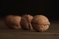 Close-up of walnut kernels and shelled nuts on a wooden table on a dark background.Healthy food, quick snack Royalty Free Stock Photo