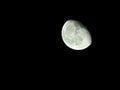 close-up of the waning three-quarter moon in the starry night sky Royalty Free Stock Photo