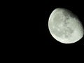 close-up of the waning three-quarter moon in the starry night sky Royalty Free Stock Photo