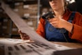 Close up of warehouse worker scanning barcodes on paper working in a large warehouse, sitting at table