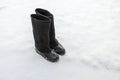 Close up of warm felt boots with rubber galoshes standing in snow on a frosty winter day.