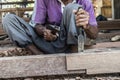 Close up of warn hands of carpenter working in traditional manual carpentry shop in a third world country.