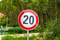 Close-up of a warning sign of the twenty kilometers per hour speed limit beside the road Royalty Free Stock Photo