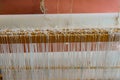 Close-up of a floor loom warp threads and heddles for textile weaving Royalty Free Stock Photo