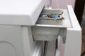 Close up washing machine dispenser tray for detergent and conditioner with corrosion, rust, pitting, mold and limescale.