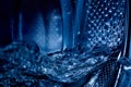 Close-up of a washing machine drum with water Royalty Free Stock Photo