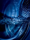 Close-up of a washing machine drum with water Royalty Free Stock Photo