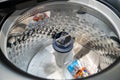 Close up of washing machine interior with agitator and detergent packs. Royalty Free Stock Photo