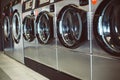Close up of washing machines in a row in a laundry, ready to cleaning services Royalty Free Stock Photo