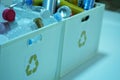 Close up Waste plastic drinking water bottles and cans in trash bins to separate recycled materials Royalty Free Stock Photo