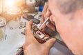 Close up watchmaker repairing mechanism old watch