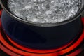 Close-up of Water Boiling In Pan on Stove Top Burner Royalty Free Stock Photo