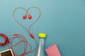Close up of water bottle,watch and red earphones Heart symbol on paper background,fitness background concept