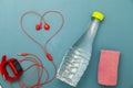 Close up of water bottle,watch and red earphones ,towel cloth on green background,fitness background concept