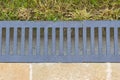 Close-up of water drain gutter that separates the lawn from the paved terrace - flatlay