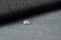 Close up water drop on grey gunny textile. Concept for easy clean, waterproof surfaces Royalty Free Stock Photo