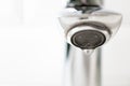 Close-up water drop from the tap with copy space, horizontal. Detail modern bathroom Royalty Free Stock Photo