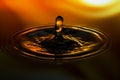 Close-up of water drop on yellow orange background Royalty Free Stock Photo