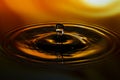 Close-up of water drop on yellow orange background Royalty Free Stock Photo