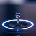 A close-up of a water droplet suspended in the air above a smooth liquid surface, Royalty Free Stock Photo