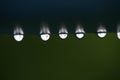 Close up of water droplets on a blue fence post