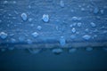 Close up of Water droplets on a blue wood fence