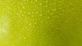 Close up water droplets on green apple skin. Macro shots