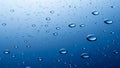 Close up of water droplets on a smooth blue surface with light reflection Royalty Free Stock Photo