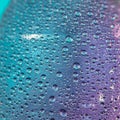 Close-up of water droplets on a smooth surface, exhibiting a range of sizes. The Royalty Free Stock Photo