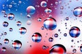 Close-up on water drops background on blue, red, white surface. Royalty Free Stock Photo