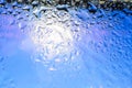 Close up of water drops on blue sky tone background.