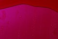 Close up of water drops on dark red tone background. Abstract red wet texture with bubbles on plastic PVC surface or grunge. Royalty Free Stock Photo