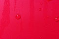 Close up of water drops on dark red tone background. Abstract red wet texture with bubbles on plastic PVC surface or grunge. Royalty Free Stock Photo