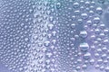 Close up water drops on lilac tone background. Abstract lilac wet texture with water drops on glass surface. Royalty Free Stock Photo