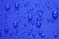 Close up Water drops pattern over a blue waterproof cloth Royalty Free Stock Photo