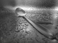 Close-up of water drops on the sink with a metal spoon. Royalty Free Stock Photo