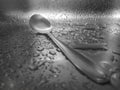 Close-up of water drops on the sink with a metal spoon. Royalty Free Stock Photo