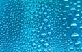 Close up water drops on sky blue tone background. Abstract sky blue wet texture with water drops on glass surface. Royalty Free Stock Photo