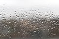 Close-up of water drops on the window glass. Rain drops on glass. Blurry backdrop, background, wallpaper, texture. Royalty Free Stock Photo