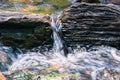 Close up of water falling through rocks on the course of a creek, California