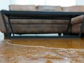 Close up of water flooding on living room parquet floor in a house - damage caused by water leakage