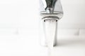 Close-up water flowing from the tap, horizontal. Detail modern bathroom Royalty Free Stock Photo