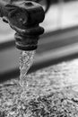 Close-up of Water flowing from a vintage garden faucet or tap. Royalty Free Stock Photo